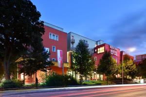 a building on the side of a street at Novina Hotel Tillypark in Nuremberg