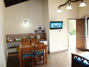 a dining room with a table and chairs and a tv at Apart Entrepiedras in Merlo