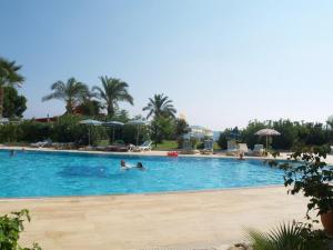 a large swimming pool with people in the water at Royal 6 Ahmet in Avsallar