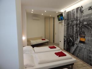 A bed or beds in a room at Kálvin Vendégszobák