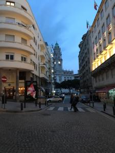 a city street with buildings and a building with a clock tower at Almada Story Apartments by Porto City Hosts in Porto