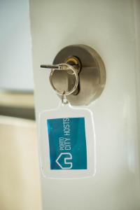 a key chain with a sign attached to a door at Almada Story Apartments by Porto City Hosts in Porto
