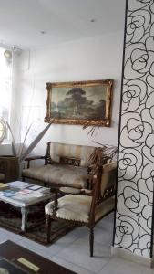 
a living room with a painting on the wall at Lolo Hotel Boutique in Mar del Plata
