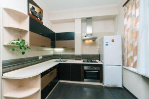 eine Küche mit einem weißen Kühlschrank und einer Spüle in der Unterkunft Двухкомнатная студио на Саксаганского in Kiew