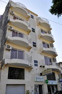 a building with balconies on the side of it at Résidence De La Porte Du Millenaire in Dakar