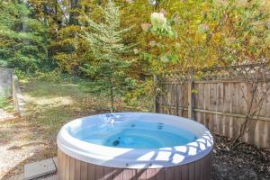 a hot tub in a yard next to a fence at The Swallow in Saugatuck