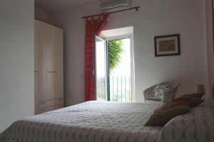 a bedroom with a large bed and a window at Monica appartamenti in San Vincenzo