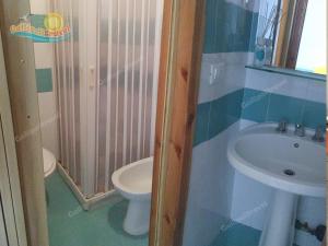 a bathroom with a toilet and a sink at Baia Verde Appartamenti Gallipolitravel in Gallipoli