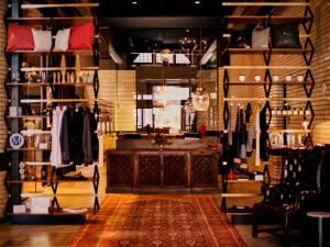 a store with a room filled with clothes on shelves at Detroit Foundation Hotel in Detroit