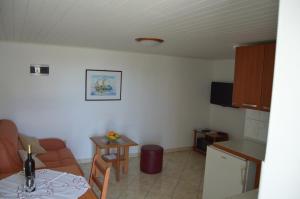a living room with a couch and a table at Apartman Latin 1 in Vodice