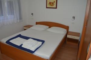 a bedroom with a bed with two towels on it at Apartman Latin 1 in Vodice