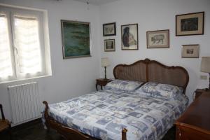 a bedroom with a bed and pictures on the wall at Villa Anna in Sorico