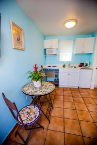 a kitchen with a table and two chairs and a table at Leucadia Beach Inn in Encinitas