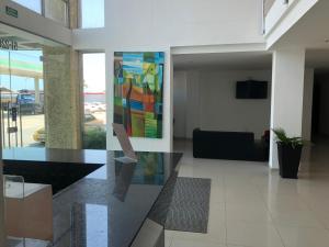 a lobby with a colorful painting on the wall at Hotel Via 40 in Barranquilla