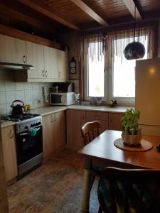 a kitchen with a table and a stove top oven at Apartament Tequila in Gdynia