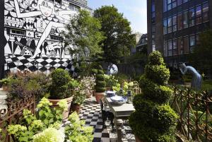 a garden with a checkered floor and plants at Andaz Amsterdam Prinsengracht - a concept by Hyatt in Amsterdam