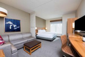 a hotel room with a couch and a bed at Hyatt Place Ann Arbor in Ann Arbor