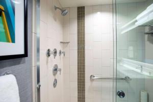 a bathroom with a shower with a glass door at Hyatt Place Cincinnati/Sharonville Convention Center in Sharonville
