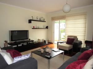 a living room with a couch and a tv at Apartment Villa Sol II in Ponta do Sol