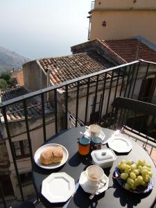 フォルツァ・ダグロにある'Casa La Zagara'のバルコニーにテーブルと食器