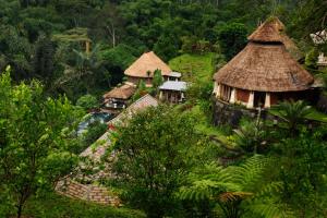 an aerial view of a village with huts and trees at Bagus Jati Health & Wellbeing Retreat in Tegalalang
