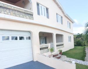 a white house with a garage at Queen Quarters USVI in Christiansted
