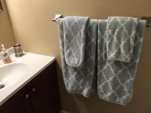 a bathroom with a sink and towels on a towel rack at Spanish Main in Cocoa Beach