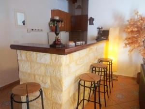 a bar with stools in front of a counter at Guesthouse Platon in Orma