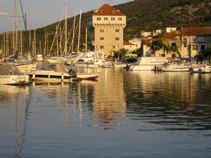 a group of boats docked in a marina with a clock tower at Apartment Marina in Marina
