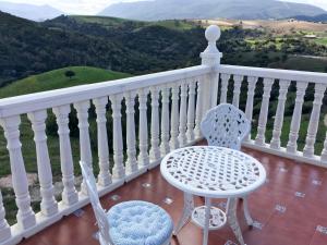 a white chair and a table on a balcony at Villa con Arte Jacuzzi By Mila Prieto in Algar