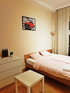 a bedroom with a bed and a car on the wall at Coser Apartamenty Centrum 1 in Warsaw