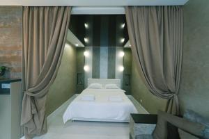 a bedroom with a large white bed and curtains at Апартаменты Гмыри 12б in Kyiv