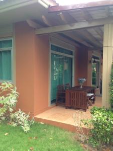 a patio with a table and chairs on a house at Casa Seaside Rayong by Chate in Rayong