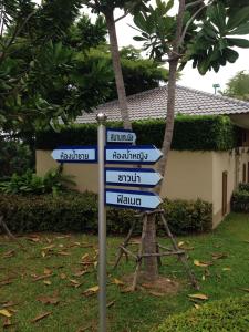 a street sign in front of a house at Casa Seaside Rayong by Chate in Rayong