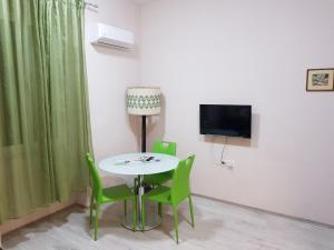 a room with a table and chairs and a television at Pavelin apartments in Split