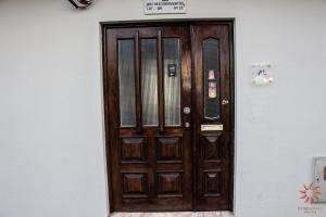 a wooden door on the side of a building at Nine Senses in Furadouro