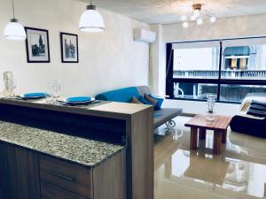 a kitchen and living room with a table and a couch at Design Apart in Montevideo