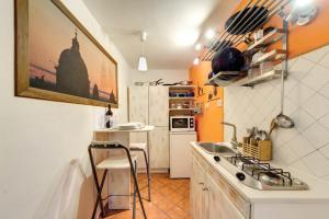 a small kitchen with a sink and a counter at Il Nido in Rome