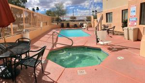 a pool with a pool table and chairs in it at Baymont by Wyndham Tucson Airport in Tucson