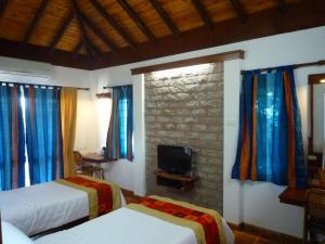 Kadambavanam Ethnic Village Resort客房内的一张或多张床位