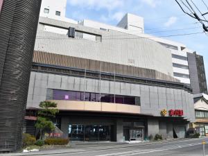 a large building with a clock on the side of it at Hotel Koshuen in Wajima