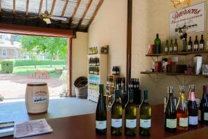 a bunch of bottles of wine sitting on a table at Petersons Armidale Winery and Guesthouse in Armidale +37 photos