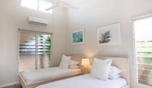 a bedroom with two beds and a window at Sols Place Boutique Pool Villas in Kalbarri