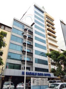 a building with a sign on the front of it at Kinabalu Daya Hotel in Kota Kinabalu