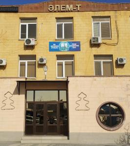a building with a sign on the side of it at Элем-Т in Aktau