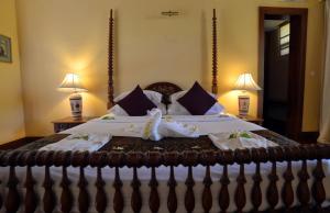 A bed or beds in a room at The Hotel @ Tharabar Gate