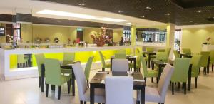 a restaurant with tables and chairs and a bar at De Palma Resort Kuala Selangor in Kuala Selangor