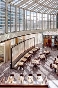a dining room with tables and chairs and windows at Hyatt Regency Denver Tech Center in Denver