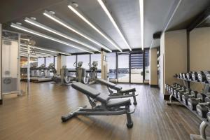 a gym with treadmills and machines in a room at Hyatt Regency Birmingham - The Wynfrey Hotel in Birmingham