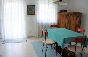 a dining room with a green table and chairs at BodenSEE Apartment 1 - 4 Daisendorf bei Meersburg in Daisendorf +2 photos